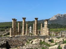 Overview of the site, presided over by statue of Emperor Trajan, which was believed to have been abandoned after an earthquake, followed by pirate incursions,  in the Third Century CE.  Baelo Claudia is said to be the best preserved Roman town on the Iberian Peninsula.