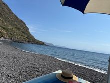 View from my lounge chair, with our striped ombrellina, above.  The sea was breaktakingly clean and clear, no plastic to be seen,, above or below water surface, despite the fact that the Rinella port (second port of Salina) is adjacent to the beach.