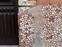 Stones embedded in facade....reminds me of the tabby of the Sea Islands.....Look at the various textures and how they meld together in a thing of beauty.