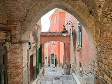 Pretty archway with pink buildings
