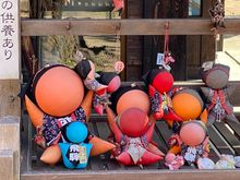 Sarubobo dolls by a small shrine 