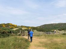 The path goes through sand dunes