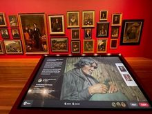 This interactive display lets you select one of the works on the wall and learn more about it