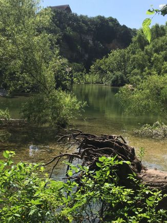 A cliff adjacent a tranquil pool, Greenbelt Trail