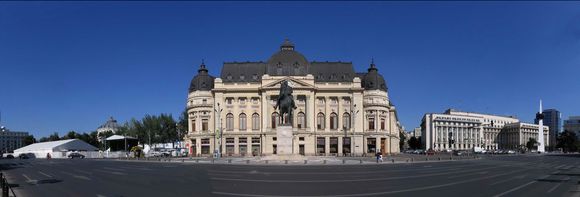 Revolutionary Square. Left to Right : Hilton Hotel ( I stayed here),Tent is Saturday Market, Dome is Concert Hall,  University Library (centre), King Carol Statue, Communist Party HQs , you can see the first floor balcony (centre of bldg.) where Ceausescu gave his last speech, was assassinated a few days later.