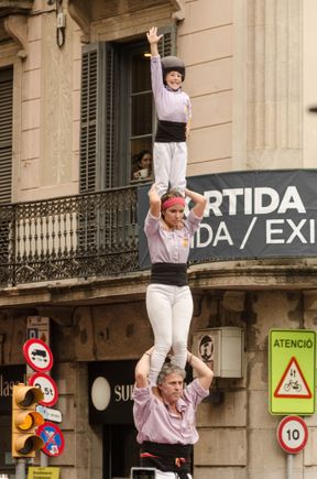 The 'enxaneta' or top child waves success to the admiring crowd. 