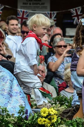 A Morris Dancer in training. Locals nudged me-the-photographer to take note of the photo op as he joyfully danced along with abandon. There was also in the parade, a similarly young boy in a stroller carriage dressed up in uniform with the label 'Grenadier Guard in Training.'