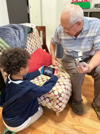 Grandad trying to fix Jays Nintendo Switch. Not successful needed a special three pronged screwdriver.