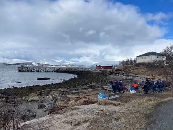 Family by the fire pit chitchatting 