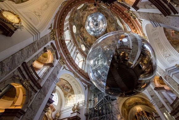 Interior of Karlskirche with sphere art installation and elevator