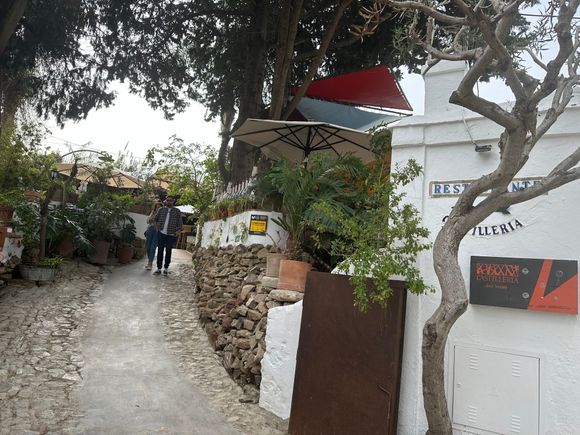 Entrance from the small street into the lush restaurant dining areas.