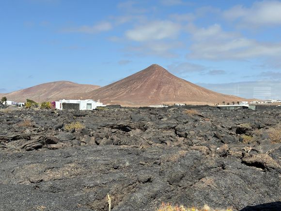 View from Manrique house....see how the low slung nearby structures do the utmost to not impair the volcanic landscape of Lanzarote.   Extinct volcanoes rise up around every bend in the road.