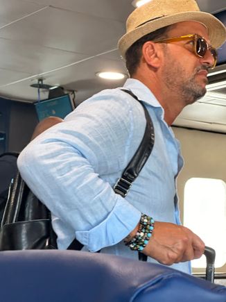 Dapper fellow tourist on boat....check out the Fedora, the glasses, the bracelets.......we KNOW that this guy is NOT an American and we can bet we know from what country he hails.....  My partner, meanwhile, wears a Yankee hat and I am in bike shorts and a t-shirt from Land's End.