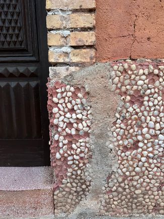 Stones embedded in facade....reminds me of the tabby of the Sea Islands.....Look at the various textures and how they meld together in a thing of beauty.
