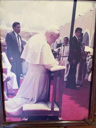 The Pope kneeling in prayer