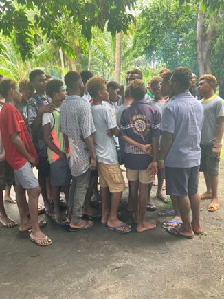 Teens from high school rugby team singing.