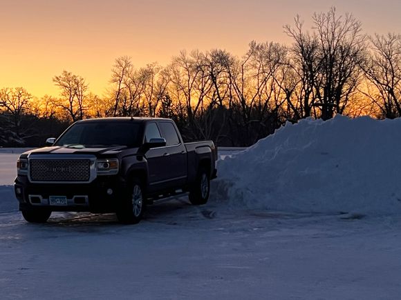 This morninbgs sunrise. Note the height of the snow pile. Parking lots all over this area now have a snow fence circling them.