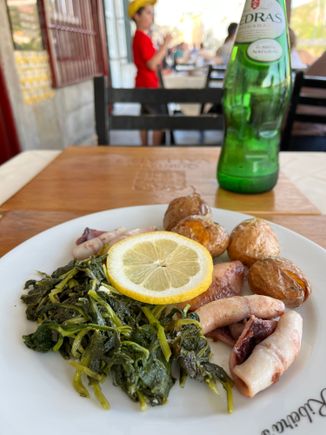 Dinner of grilled squid with potatoes and greens