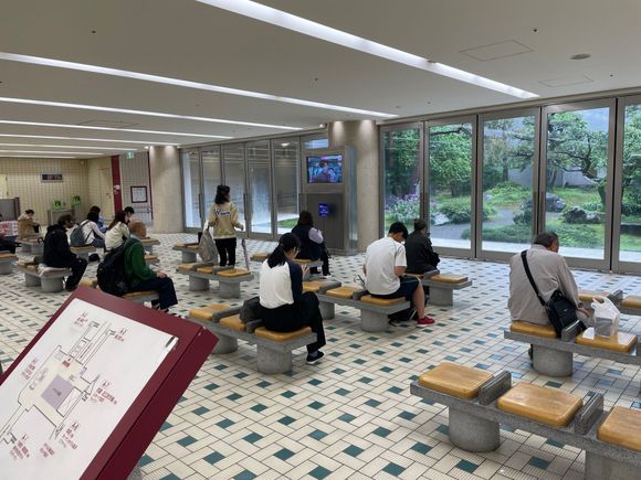 Here are a bunch of travelers, I guess, sitting in this space with a TV screen, and looking out the picture windows.