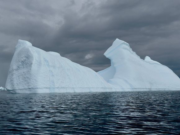 Well, the kayaking trip started out sunny… But fortunately, the gray clouds did not bring any precipitation, but did provide a nice backdrop to this iceberg.