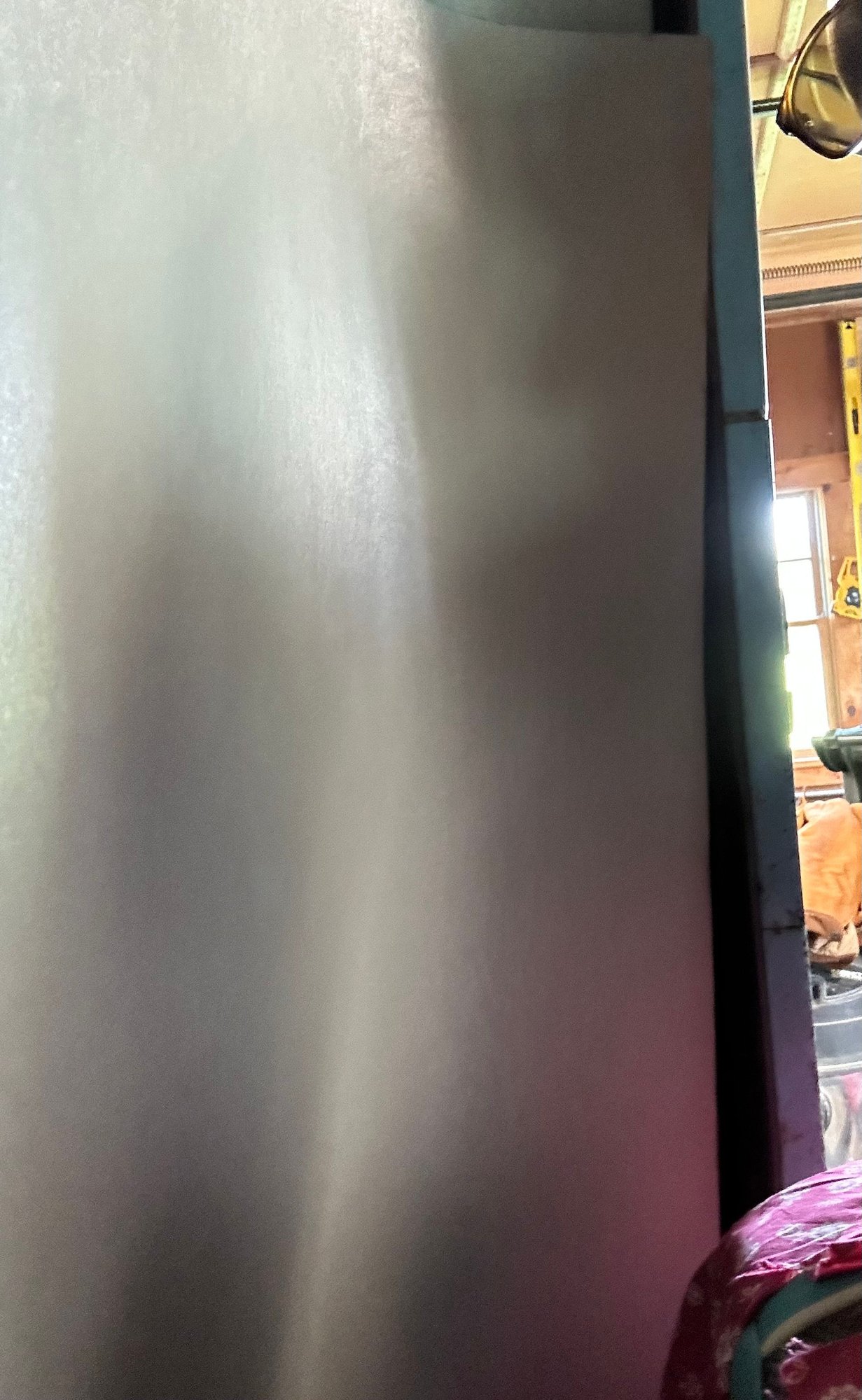 Side of panel along edge of door. You can see how as it lines up from top to bottom the bottom moves away from them door edge and cant seat in the molding Do I secure this side in place first with a couple of screws. And then push everything else into place along the bottom to get the top to line up? 
