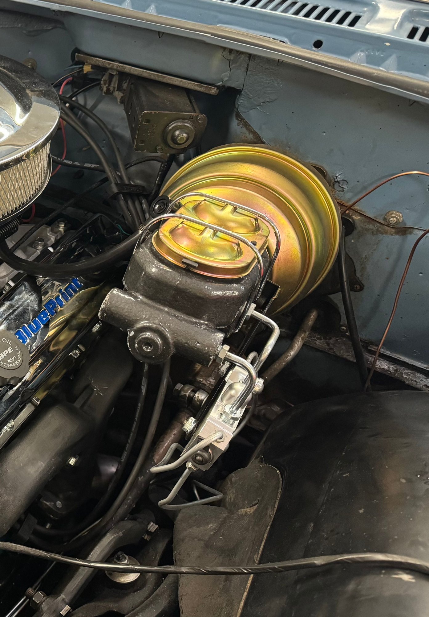Mine is oriented different but you can see the two lines that come out of the front of my proportioning valve and go directly to each front wheel. Those are fed by the port on the MC that is nearest us in the picture. 