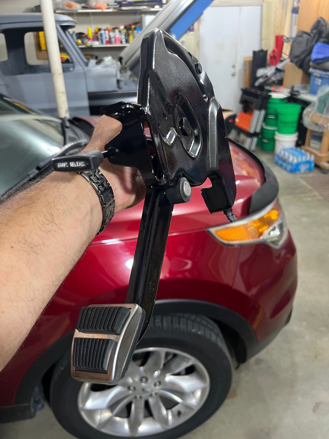 Parking brake assembly cleaned and painted, new trim installed on the pedal