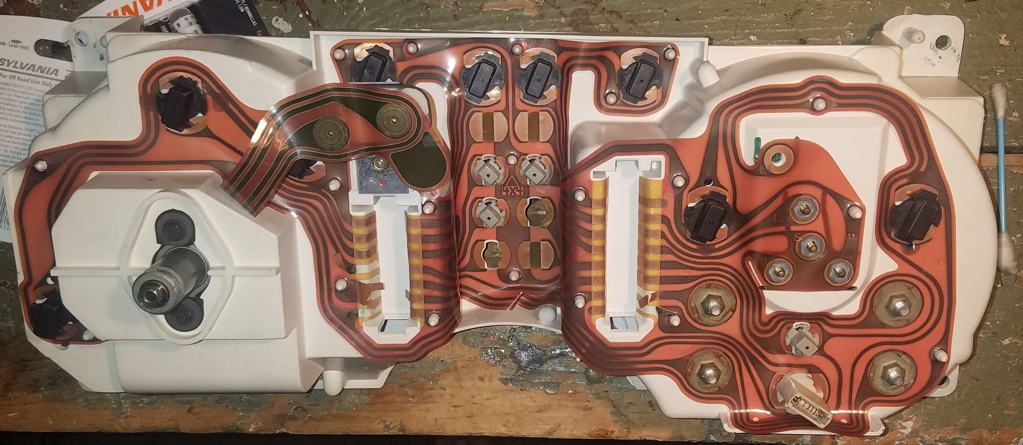 The backside of the cluster showing all the bulb sockets.  Theres 2 different sizes.  6 small and 8 large.  You can buy the sockets at Advanced Auto if you should need to.