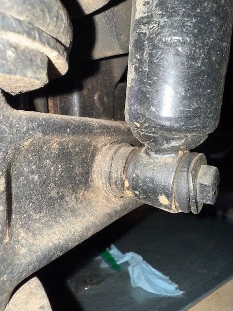 Front shock in the front passenger pair (note the stack of washers to build out the I-beam surface) 
