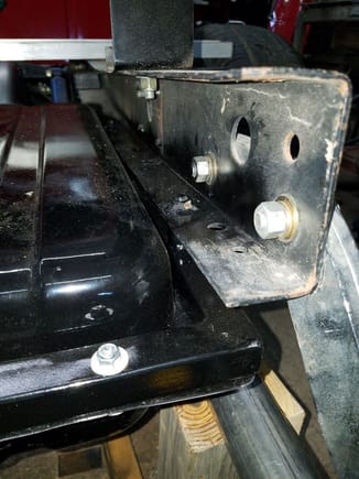 The nuts are welded to the truck frame where you do not have to fiddle reaching in the frame to tighten.  Tank frame is bolted to tank with several 1/4" bolts