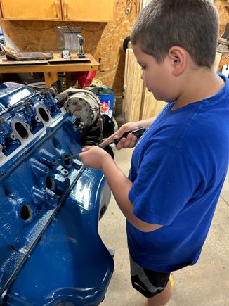 But of course, the first one he did, he knocked it clear into the block and I had to dig it out. There’s nothing like learning when you make a mistake, but this was an easy one to correct and he did the others perfect. So then after we got those out, we were scraping the crud that was right around him cleaning the holes out getting them ready for the new ones and then his friends came by and he decided he wanted to go play.