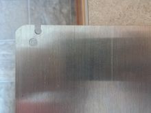 Drill a hole, then notch the plate using a tin snips or even a wire cutter/side cutter/dikes