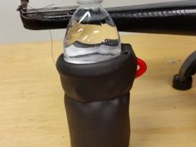 Vinyl placed over the top of cup holder and a seam sewn below it.  This will keep the cover from coming off.