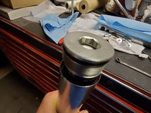 Spacer, washer and fork tube cap.  Preload is measured from the top of the fork tube to the underside of the tube cap's top sealing surface.  This is the distance the spring will be compressed when the cap is threaded all the way down and tightened.