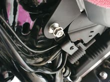 Remove the front screw next to the ignition switch holding the petrol tank