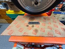 Lay bar on work surface, lay hub on the parallel bar.