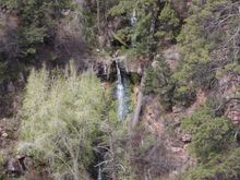 little water fall coming fro a spring, (or fracture in the rock and it's water from the reservoir)