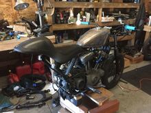 Ordered a cycle standard blackbird tank, antigravity battery, coil relocation kit from dk customs, 883 superlow split five spoke rear wheel, shinko 705 series tires in 110/80-r19 and 170/60-r17.  Already have renthal fat bars with joker machine bar mount, joker machine fork mounted speedo housing, joker machine bar end mirror, revival cycles clutch lever, nissin front brake master cylinder, biltwell whiskey throttle with a custom 7/8"-1"  throttle spacer, barnett idle and throttle cables, etc.