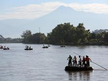 1.  People cross into Mexico, rafting across the Suchiate River from Guatemala, on August 2, 2013 in Ciudad Hidalgo, Chiapas, Mexico. Thousands of undocumented Central Americans pass illegally through Mexico, many of them immigrants on the first leg of their long and perilous journey north to the United States.
