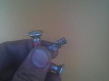 this is what was left of the bolt that was rattling around in my primary for a few states. and the replacements ones. total damage:that new Baker tranny rod, the clutch basket, my new Barnett clutches....... i was not happy. again, Alabama Biker Supply, Huntsville, Alabama......
