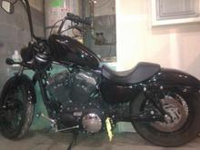 Side shot of the new shocks, blacked out tank and relocation of the stock license bracket. Rewired it back through so the led still works.