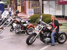 hanes city bike night,  prior to bike show,   Peanut sitting on Little Miss Bobber with Skully in the back ground.