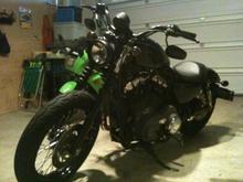 2009 1200N, Black Bullet style Headlight, flat black heat shields and A/C, flipped mirrors, relocated turn signals w/ smoked lenses, drilled stock baffles