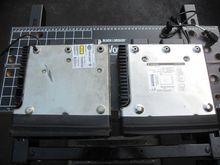 Both the PMX-HD9813 and the HD, bottom view. NOTE: difference in the size of the holes on the feet. Stock radio had a zip tie (HD part number: 10073 which is a "cable strap, rosebud mount"). This cable strap will not fit into the smaller hole on the RF radio