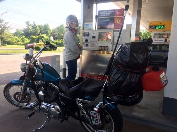 This is how all our road trips start out (see gas station picture). Riders who has a “48” or “72” know this sight very well as the small 2.2gal tank needs topped off very frequently. Also a keen eye will notice my bike is set up in ”touring mode” aka, a sundowner seat and stock shock adjustment and of course the small gas can dangling off the bag. 
Of course my wife is smiling as the old saying goes. “even the worst day on the Harley is better than the best day at work”.
