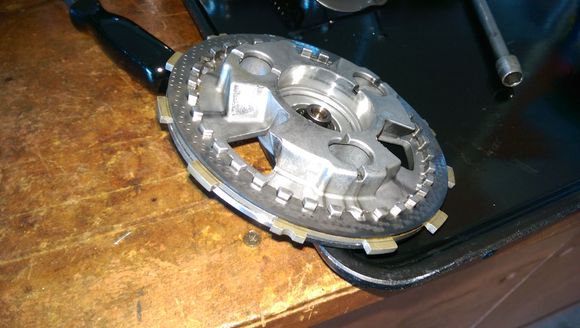 SM is wrong about how to install the cover. Place only the first friction and steel on the pressure plate.  SM says friction, steel, friction but it's easier to put the one friction in the clutch basket.