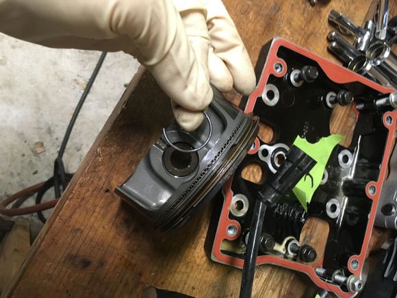 I stuffed clean shop rags in the crank case In case one of the piston c clips went flying. I removed one per piston using a flat pocket screwdriver, then pushed the wrist pin out from the opposite side. There is a tool in the SM for c clip removal. I've always used a flat screwdriver without struggling.