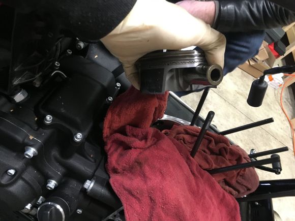 Piston wrist pin removal after removing one c clip. I also install one on each piston before installing it onto the rods. Easier to do them on a bench.