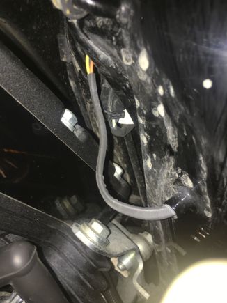 This is a shot of the fuel gauge wiring.  There is also a clip that holds it.  I found it easiest to remove the front tank bolt, and loosen the rear, then remove the cross under tube under the front of the tank. I clamped the fuel line from the left side, then covered the right side with my finger.  Next I lifted the front of the tank, and reinstalled the cross under tube above the frame, and let the tank rest on it. This elevated the tank just enough for me to see/remove the clip and gaugewIres