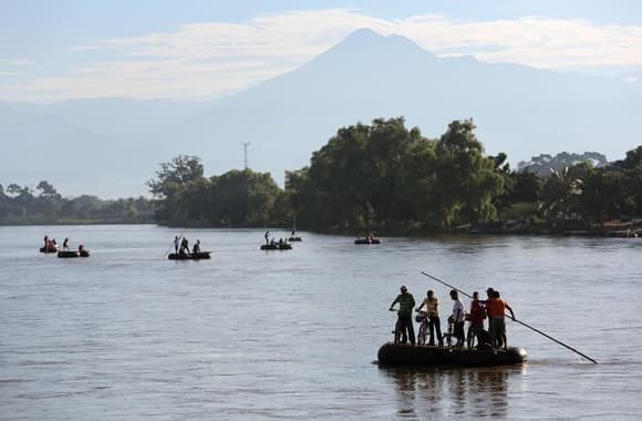 1.  People cross into Mexico, rafting across the Suchiate River from Guatemala, on August 2, 2013 in Ciudad Hidalgo, Chiapas, Mexico. Thousands of undocumented Central Americans pass illegally through Mexico, many of them immigrants on the first leg of their long and perilous journey north to the United States.